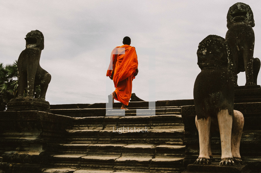 Buddhist monk walking up stairs 
