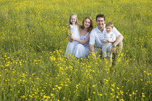 Family portrait in a field of wildflowers 