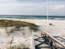 boardwalk and flagpole on a beach 