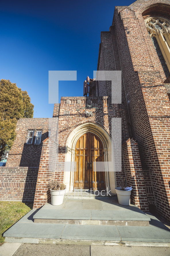brick church with arched doors 