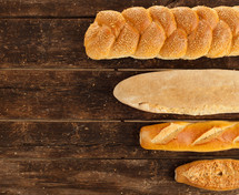 Variety types of bread on wood table.
