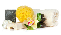 Accessories for spa with soap bar, rchid flowers, stones, sponge and towel on white background