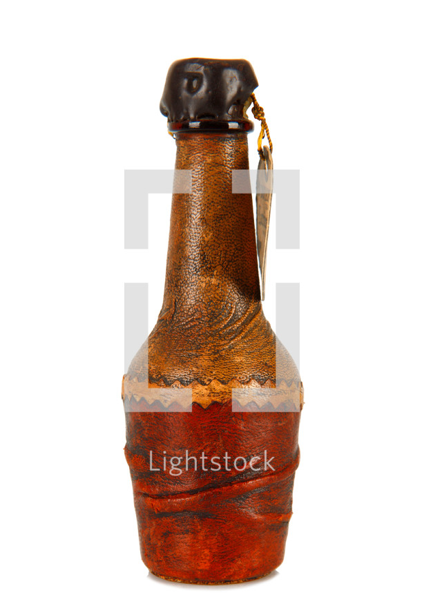 Mini bottle covered in leather on white background