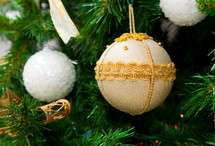 Christmas ball, white and gold on christmas tree
