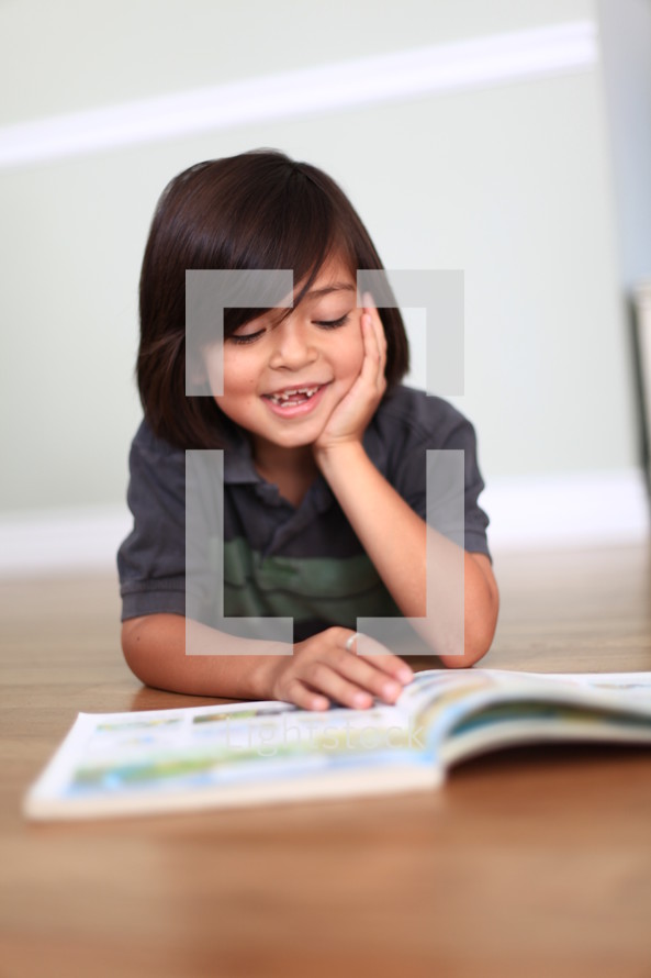 little boy missing teeth reading