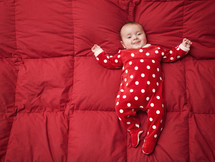 Newborn baby with Christmas suit with polka dot patterned