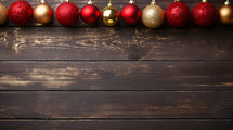 Red and gold Christmas ornaments and decorations on a wood background