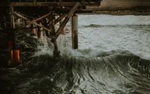 waves crashing into a pier 