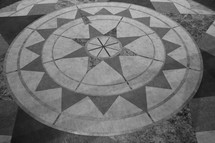 Artists representation of the points of a compass set into stone.