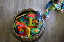 an infant playing in toys 