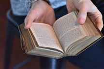 a person reading an old Bible 