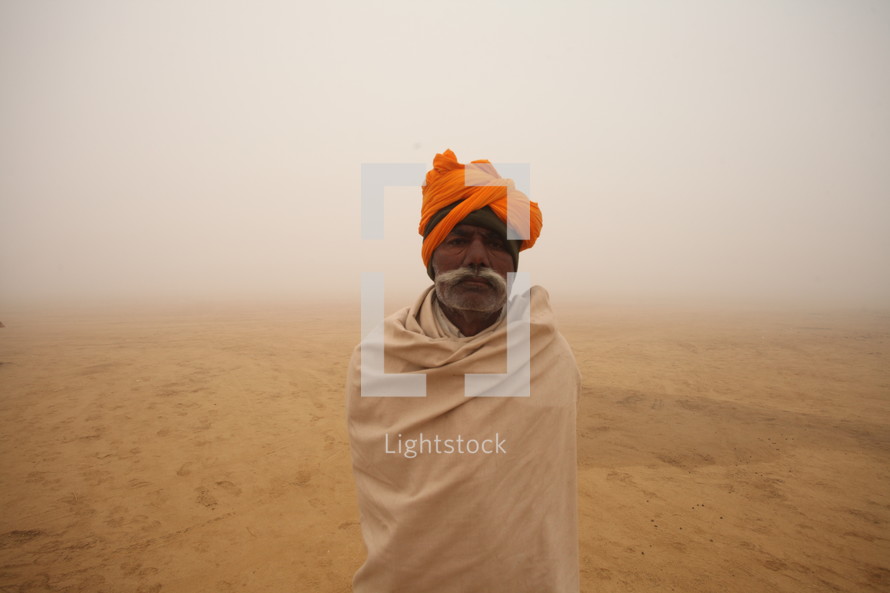 man standing in a desert during a dust storm 