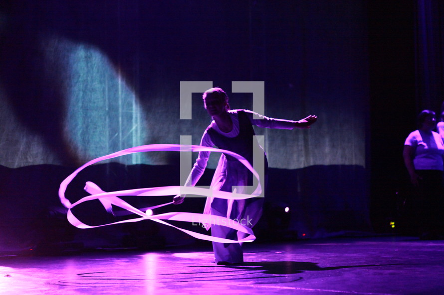 performer ribbon twirling on stage