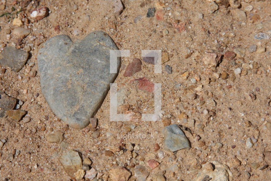 Heart shaped stone in the dirt