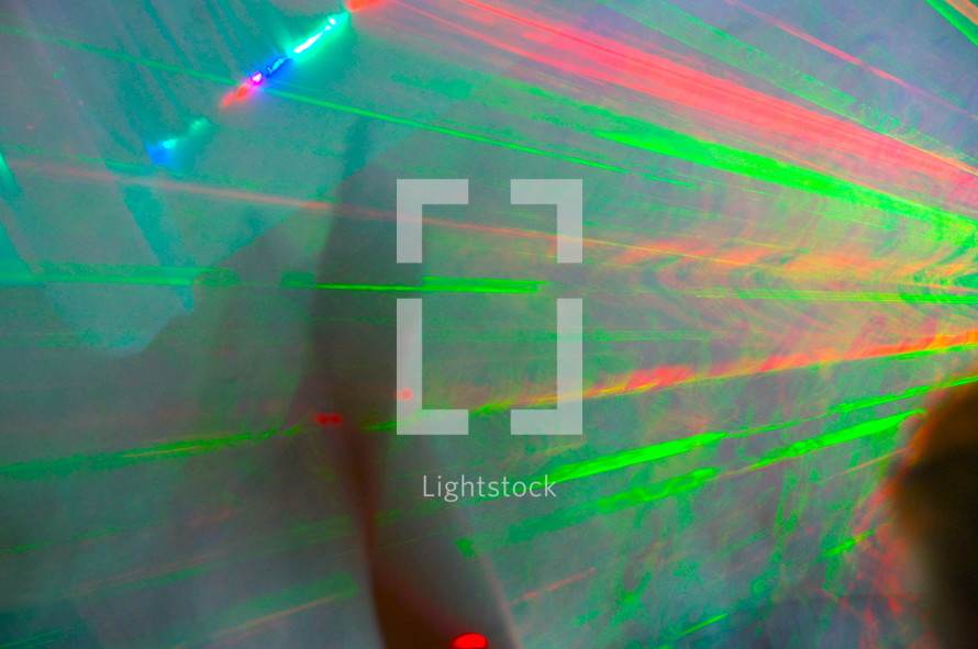 Streaks of laser light through a smokey room