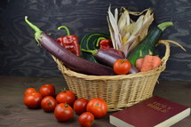 harvest basket and Holy Bible on a wood background 
