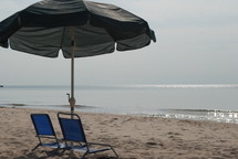 chairs and umbrella on a beach 