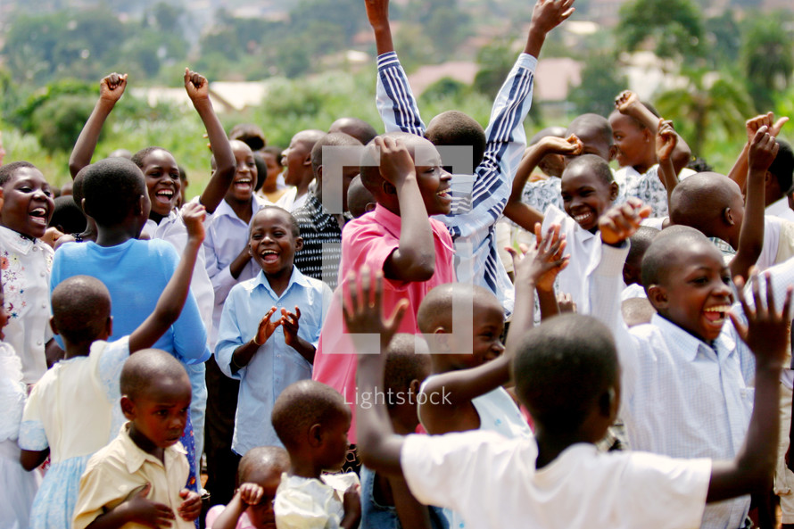 Group of African children youth  praising God joy dancing