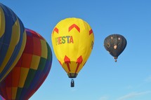 hot air balloons against a blue sky 