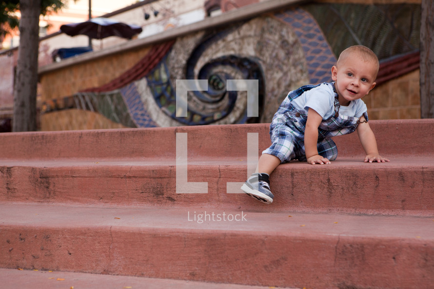 toddler boy climbing stairs