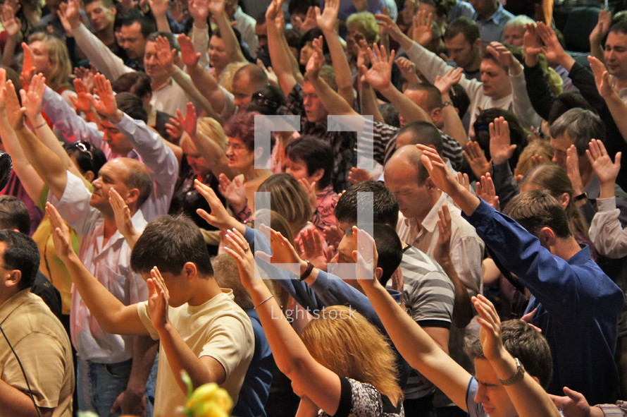 Hands raised to accept Christ. 