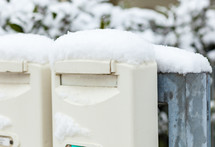 Mailboxes draped with a layer of freshly fallen snow.