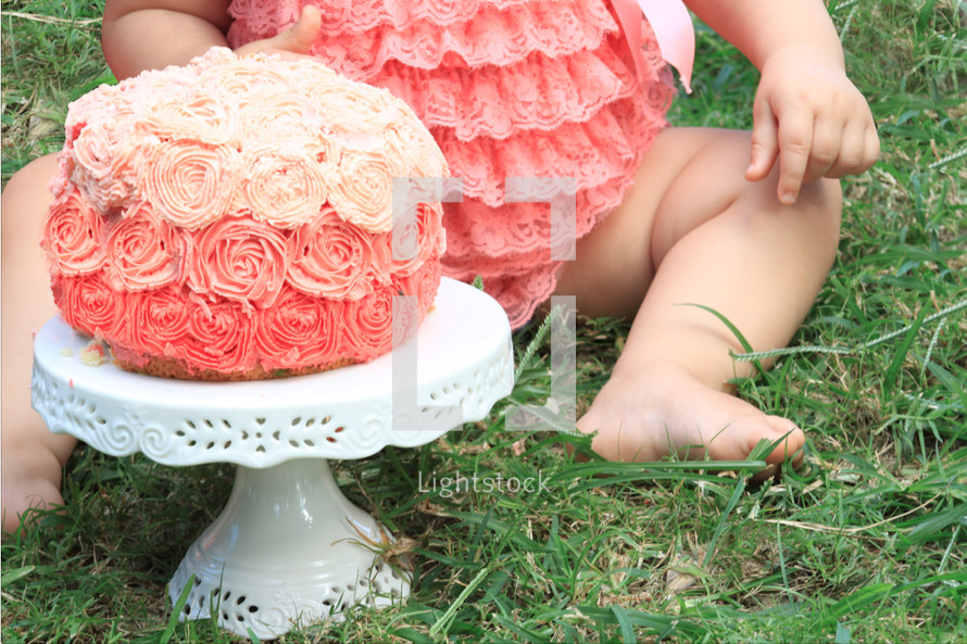 infant girl and a cake in peach 