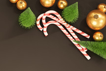 candy canes and ornaments on a black background 