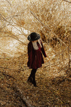young woman in a maroon coat in fall 