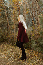 young woman in a maroon coat in fall 