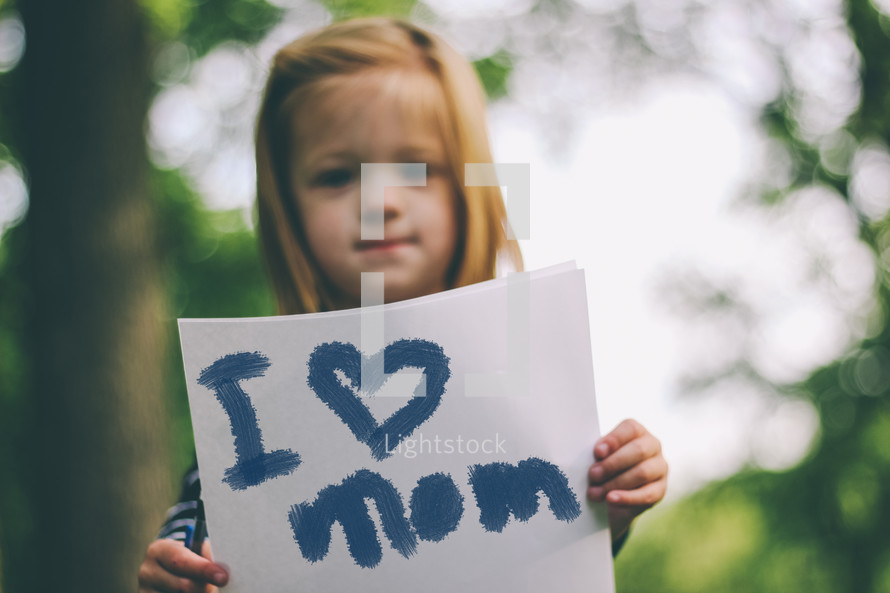 "I love Mom" sign held by a child.
