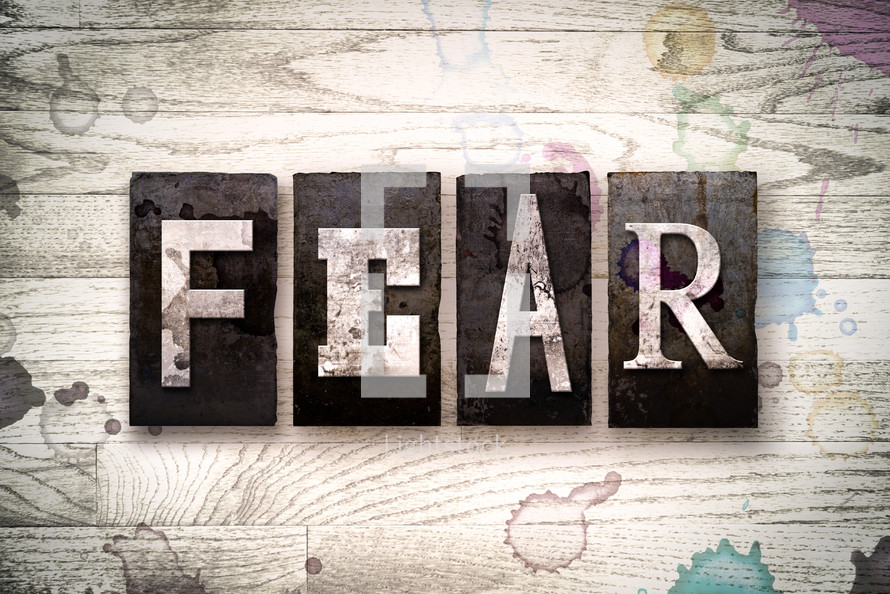 word fear on wood background 