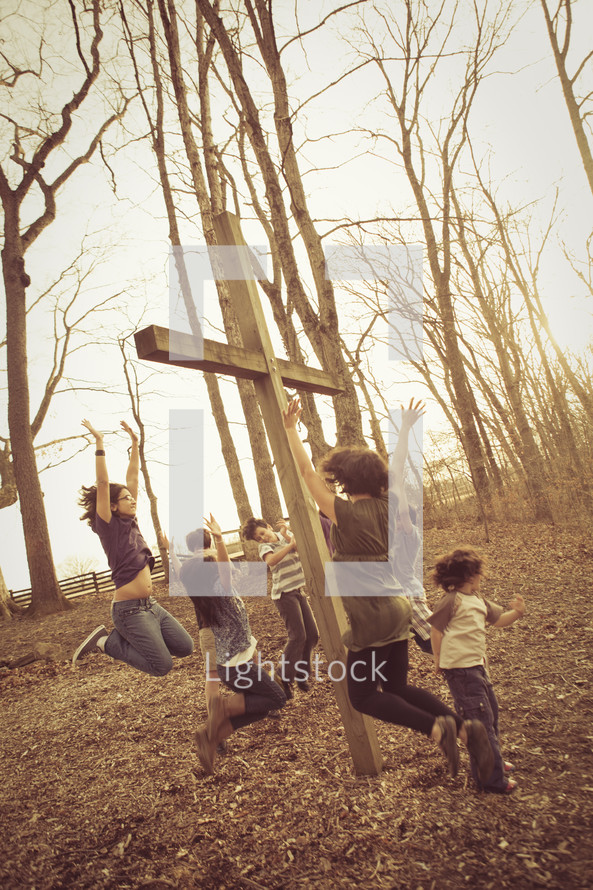 jumping for joy around a cross outdoors 