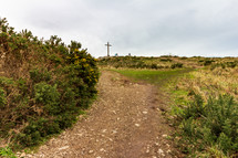 A rocky path leading toward the cross located high atop Bray Head in County Wicklow, Ireland