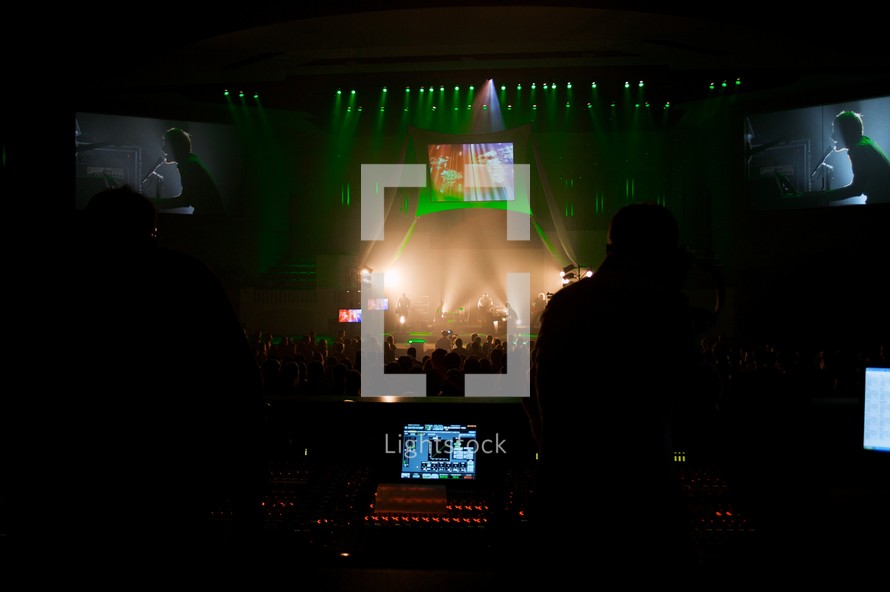 projection screens over a stage a concert