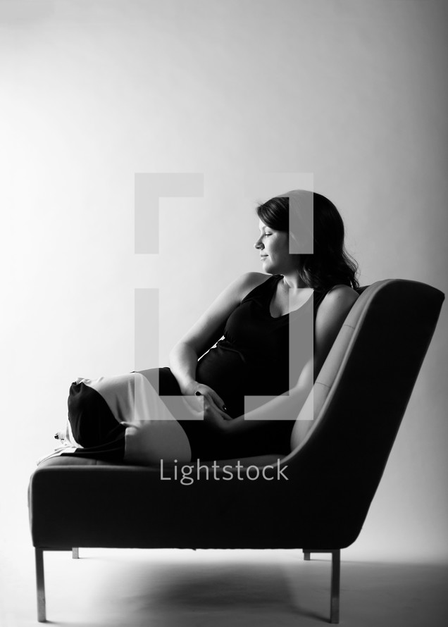 pregnant woman sitting on a chair 