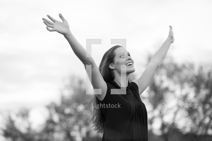 woman with arms raised to the air 