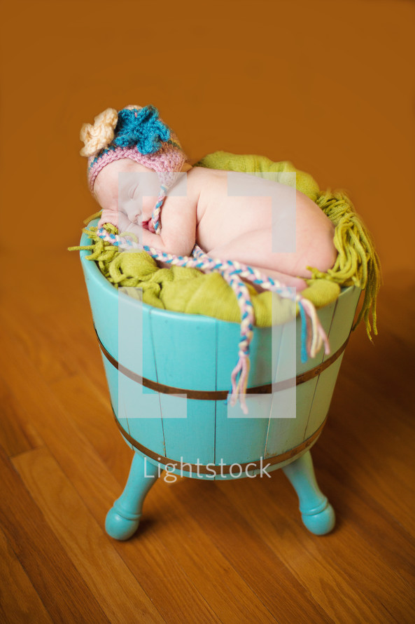 naked newborn in  a hat