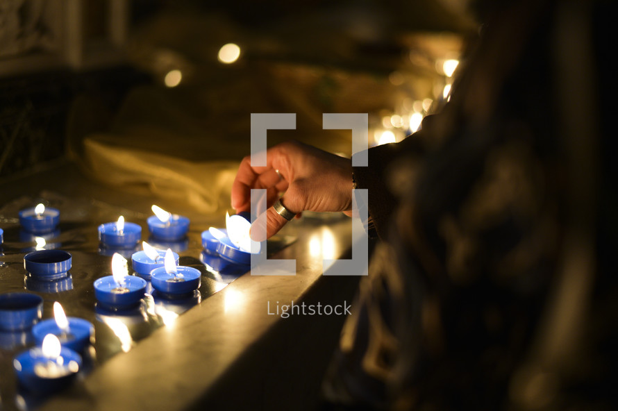 lighting votive prayer candles 