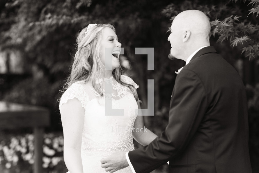 A bride and groom laughing together wedding day husband and wife 