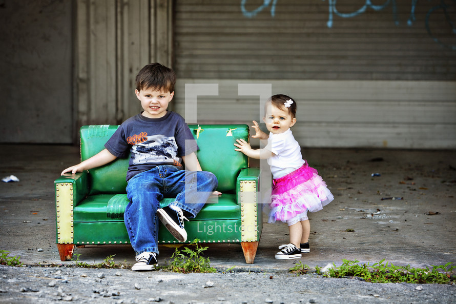 Little boy and girl sitting on a couch