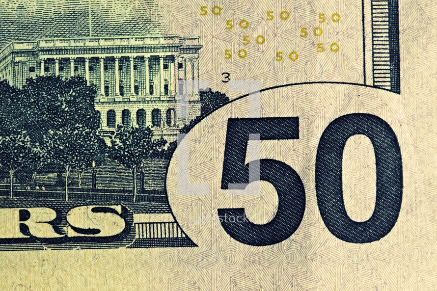 An extreme closeup of a fifty dollar bill