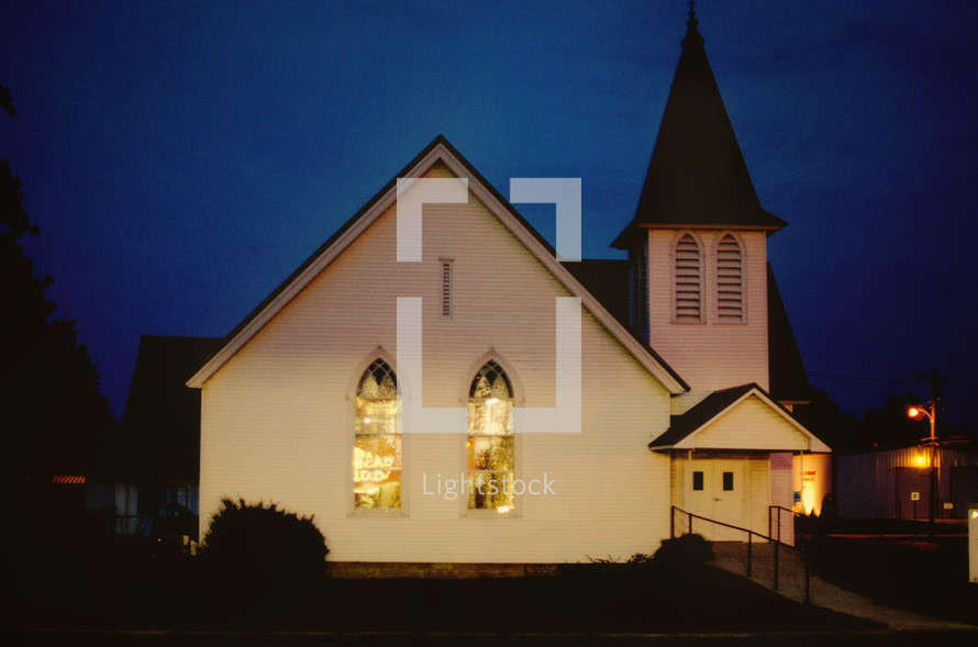 A white church against a night  sky.