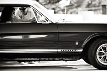 man leaning through a 1966 ford mustang  car window talking to a woman romance love