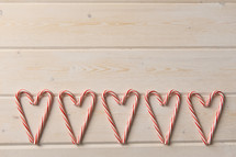 row of candy canes in the shape of hearts 
