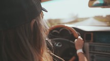 a woman driving a convertible 