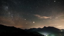 Milky way galaxy stars night sky over mountains Time lapse

