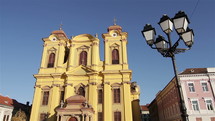 European catholic church with pigeons flying. Timisoara - Romania.
