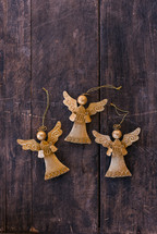 gold angel ornaments on wood background 