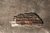 exposed brick on a plastered wall 